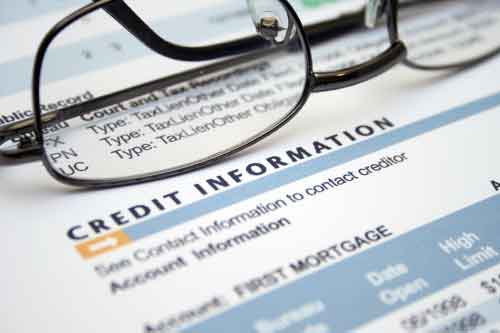 A pair of glasses sitting on top of a credit information form.