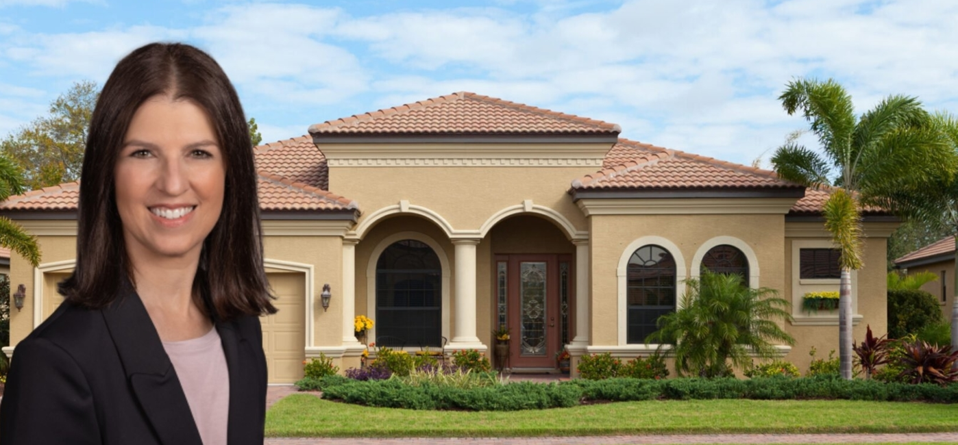 A woman standing in front of a house.